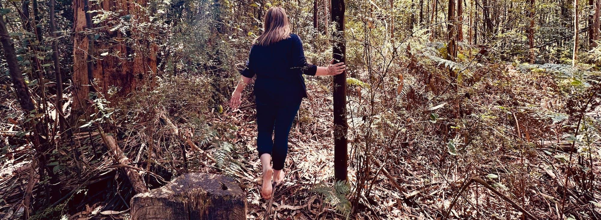 image of practitioner walking through forest